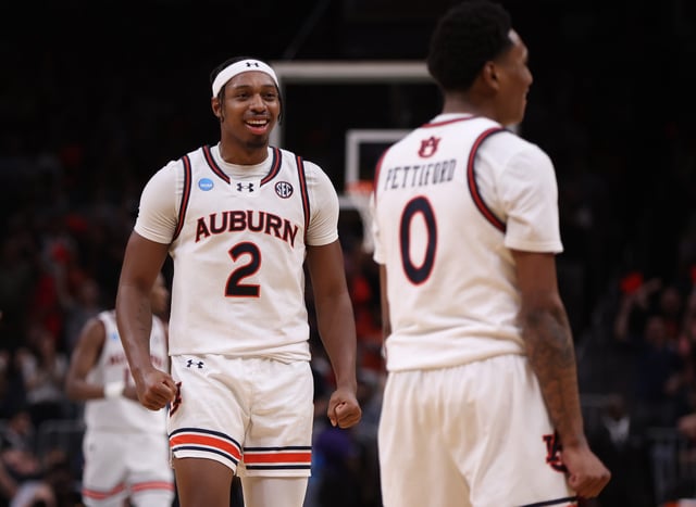 Auburn Tigers guard Denver Jones (2) celebrates with guard Tahaad Pettiford (0) after a basket in the second half of a South Regional semifinal of the 2025 NCAA tournament against the Michigan Wolverines at State Farm Arena.