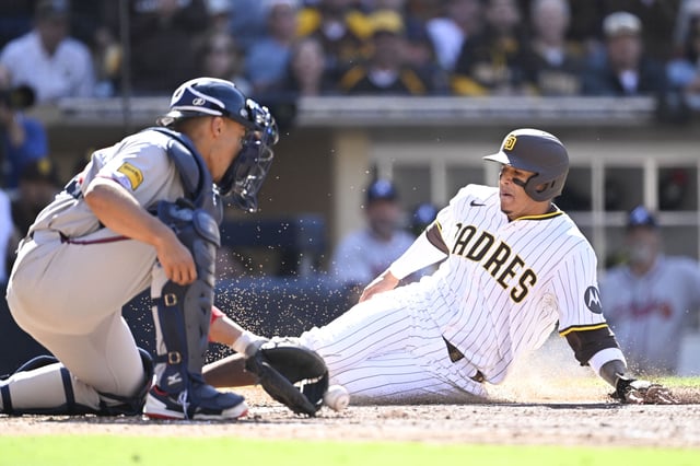 Mar 27, 2025; San Diego, California, USA; San Diego Padres third baseman Manny Machado (13) scores ahead of the throw to Atlanta Braves catcher Drake Baldwin (30)  during the seventh inning of a baseball game  at Petco Park. Mandatory Credit: Denis Poroy-Imagn Images/File photo