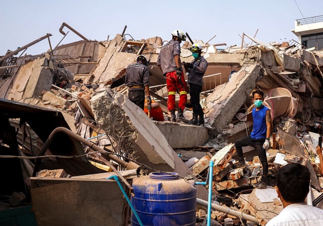 Rescuers work at the site of a building that collapsed, in the aftermath of a strong earthquake, in Mandalay, Myanmar, March 30, 2025. REUTERS/Stringer