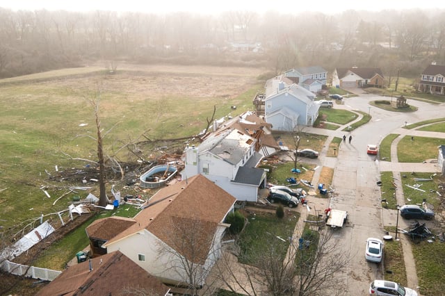 Debris lies around damaged houses the morning after a tornado touched down in Florissant, Missouri, on March 15.
