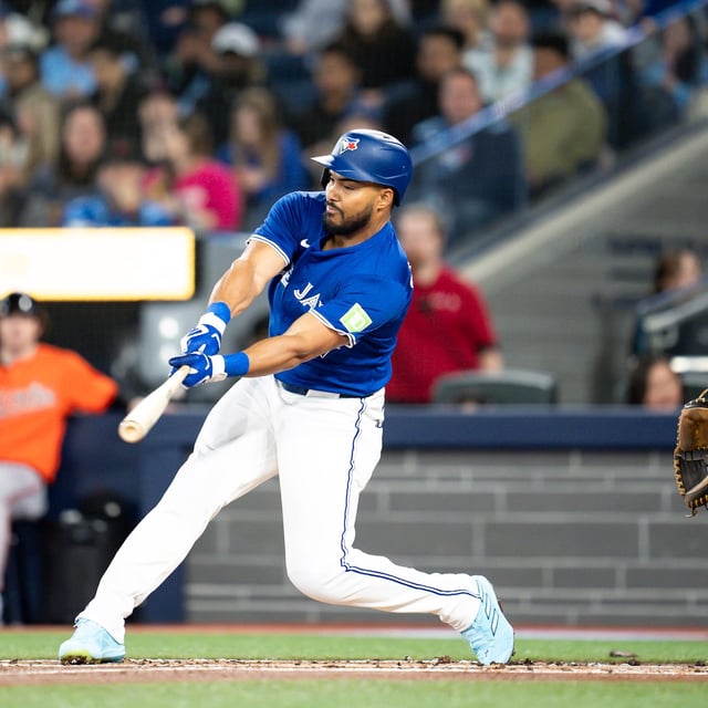 Blue Jays outfielder Anthony Santander (25) hits an RBI single against the Baltimore Orioles in the first inning of Toronto's 9-5 loss on Saturday, March 29, 2025. THE CANADIAN PRESS/Christopher Katsarov