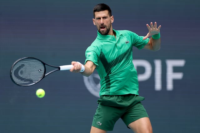 Novak Djokovic of Serbia returns a shot to Grigor Dimitrov of Bulgaria during the semifinals of the Miami Open Presented by Itau at Hard Rock Stadium on March 28, 2025 in Miami Gardens, Florida.