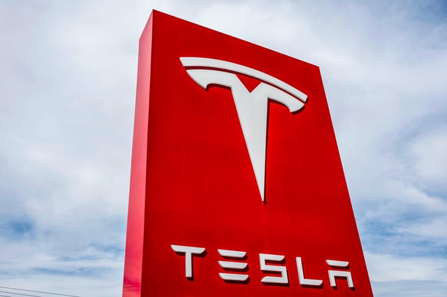Signage at a Tesla store in Colma, Calif., on March 10, 2025.