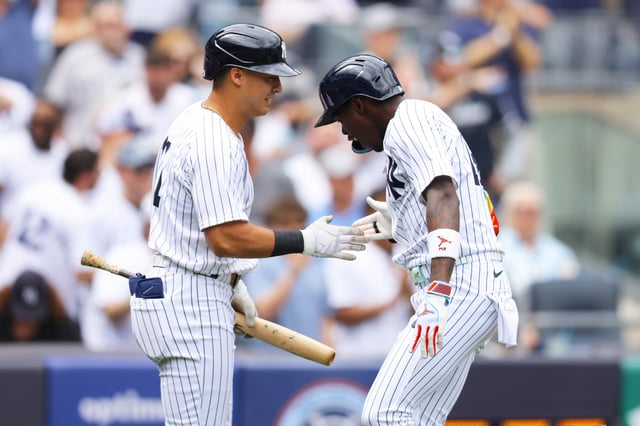 NEW YORK, NEW YORK - MARCH 29: Jazz Chisholm Jr. #13 of the New York Yankees celebrates with Anthony Volpe #11 after hitting a third inning home run against the Milwaukee Brewers at Yankee Stadium on March 29, 2025 in New York City.