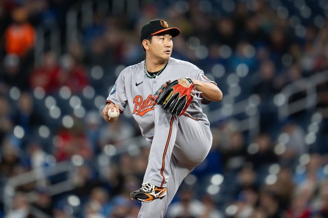 Baltimore Orioles pitcher Tomoyuki Sugano winds up to throw during first-inning baseball game action against the Toronto Blue Jays in Toronto, Sunday, March 30, 2025. (Christopher Katsarov/The Canadian Press via AP)