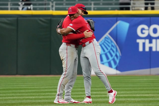 Angels left fielder Taylor Ward, left, hugs center fielder Kyren Paris after the Angels defeated the Chicago White Sox in a baseball game in Chicago, Sunday, March 30, 2025. (AP Photo/Nam Y. Huh)