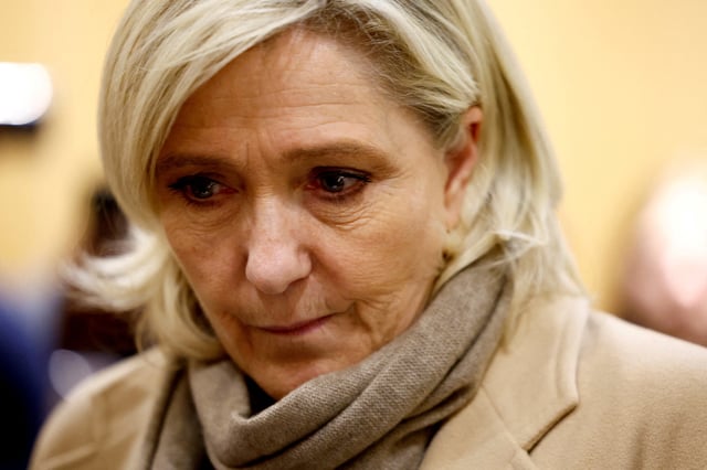 FILE PHOTO: French far-right leader Marine Le Pen, member of parliament of the Rassemblement National (National Rally - RN) party, talks to journalists as she leaves on the last day of her trial in Paris, France, November 27, 2024. REUTERS/Stephanie Lecocq/File Photo/File Photo
