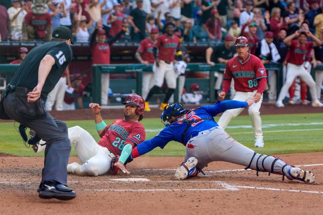 Mar 30, 2025; Phoenix, Arizona, USA;  Chicago Cubs catcher Miguel Amaya (9) makes the tag to out Arizona Diamondbacks infielder Eugenio Suárez (28) in the eighth inning during a game at Chase Field. Mandatory Credit: Allan Henry-Imagn Images