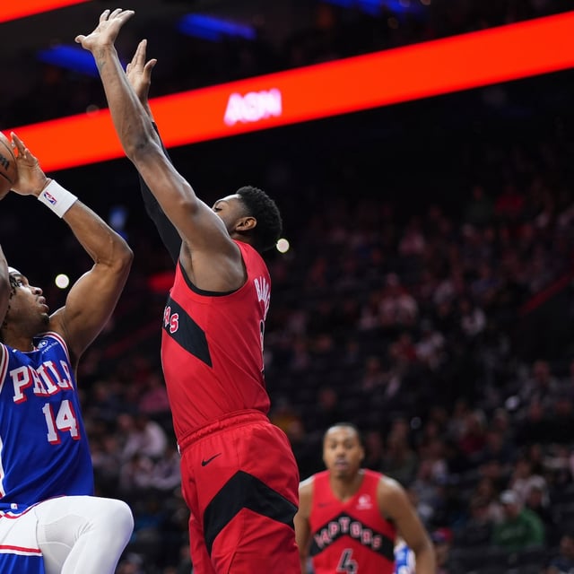 Philadelphia 76ers' Ricky Council IV, left, goes up for a shot against Toronto Raptors' RJ Barrett during the first half of an NBA basketball game Sunday, March 30, 2025, in Philadelphia. (AP Photo/Matt Slocum)