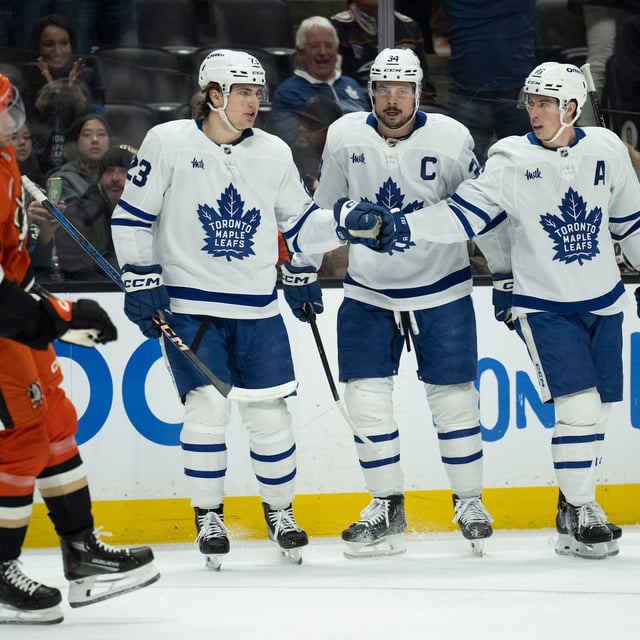 Toronto Maple Leafs right wing Mitch Marner (16) celebrates after his goal with center Auston Matthews (34) and left wing Matthew Knies (23) during the second period of an NHL hockey game against the Anaheim Ducks, Sunday, March 30, 2025, in Anaheim, Calif. (AP Photo/Kyusung Gong)