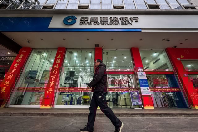 A man walks past the entrance of a China Construction Bank branch in Chongqing, China, on December 29, 2024.