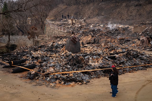 Buildings, including Gounru Pavilion at Gounsa Temple in Danchon-myeon, Uiseong County, North Gyeongsang province, stand in ruins after being destroyed by a wildfire in South Korea on March 28, 2025.