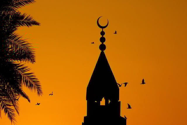 Birds fly around the minaret of the Ali bin Ali mosque at the start of the Eid al-Fitr which marks the end of the holy Muslim fasting month of Ramadan, in Doha on March 30, 2025.