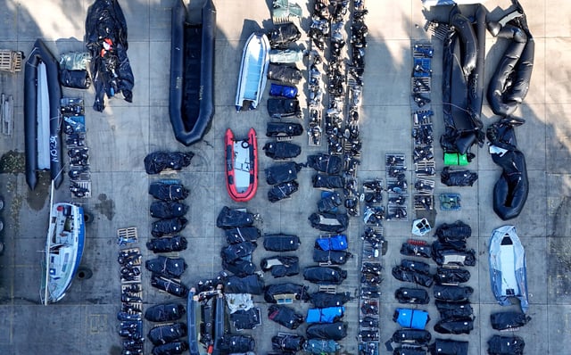 Small boats and outboard motors used by suspected people smugglers, stored in a Dover warehouse