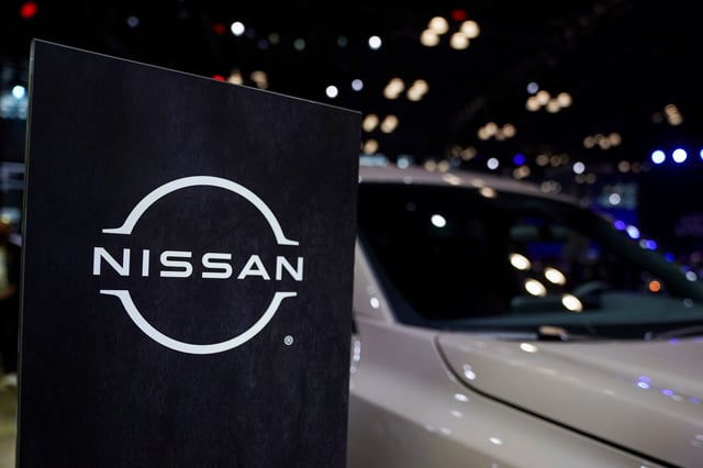 A Nissan logo is seen next to a vehicle during the New York International Auto Show, in Manhattan, New York City, U.S., April 5, 2023. REUTERS/David 'Dee' Delgado/File Photo