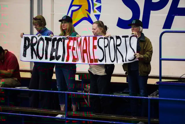 A group with Women Are Real and Independent Council on Women’s Sports disrupts a San Jose State women’s volleyball game with a banner as the team competes against UNLV in San Jose in October. San Jose State had a transgender volleyball player on its squad and some teams chose to forfeit rather than play the Spartans.