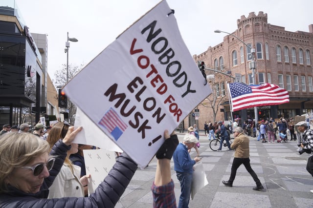 Protesters hold a demonstration outside a Tesla showroom in Santa Monica, Calif., on Saturday, March 29, 2025, against U.S. President Donald Trump and Tesla CEO Elon Musk. (AP Photo/Damian Dovarganes)