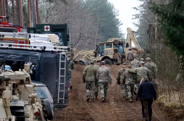 Military personnel work at the site of a rescue operation for missing US soldiers at Pabrade training ground, in Lithuania, on March 28.