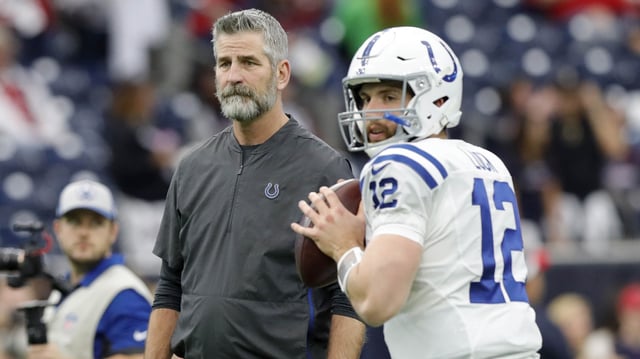 Head coach Frank Reich of the Indianapolis Colts watches as Andrew Luck warms up before the game against the Houston Texans during the Wild Card Round at NRG Stadium on Jan. 5, 2019 in Houston, Texas.