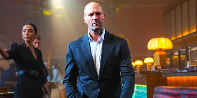 Jason Statham as Levon Cade wearing a suit in A Working Man.