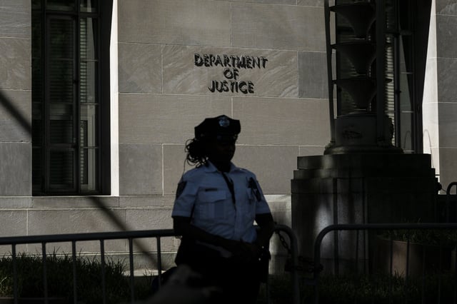 A police officer stands guard outside the US Department of Justice building in Washington, DC, in 2024.