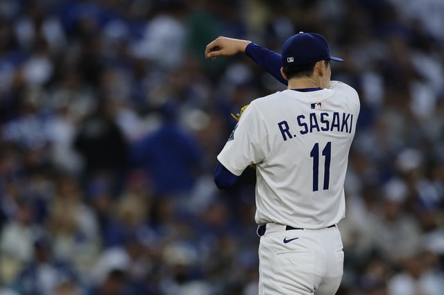 Roki Sasaki #11 of the Los Angeles Dodgers leaves the game during the second inning against the Detroit Tigers at Dodger Stadium on March 29, 2025 in Los Angeles.