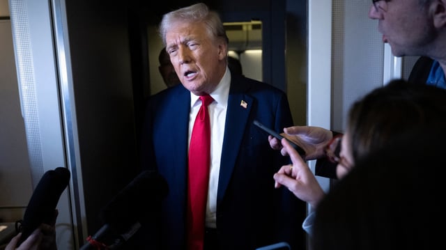 President Donald Trump talks to reporters on Air Force One