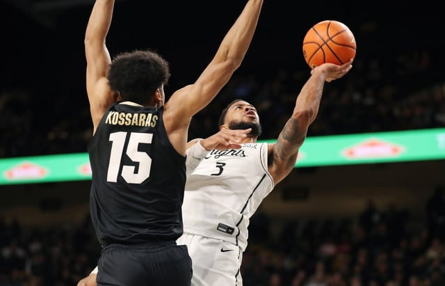 UCF guard Darius Johnson (3) shoots beside Colorado guard Felix Kossaras (15) during the Colorado at UCF NCAA basketball game in Orlando on Wednesday, January 8, 2025. (Stephen M. Dowell/Orlando Sentinel)