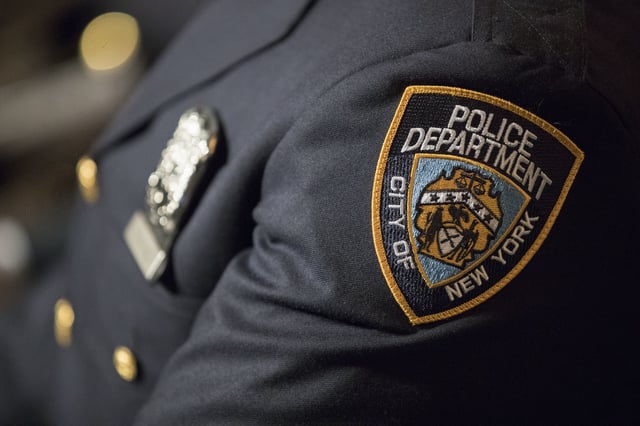 FILE- A detail including the badge and shield of one of the newest members of the New York City police is seen during his graduation ceremony, Thursday, June 29, 2017, in New York. (AP Photo/Mary Altaffer, file)