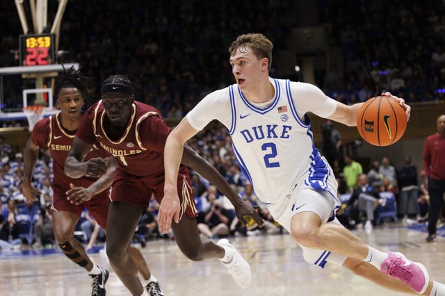 Duke&#39;s Cooper Flagg (2) drives past Florida State&#39;s Jerry Deng, second from left, during the second half of an NCAA college basketball game in Durham, N.C., Saturday, March 1, 2025.