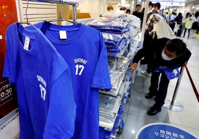 A man chooses T-shirts at a pop-up store for Major League Baseball (MLB) star Shohei Ohtani ahead of the first World Series game between the Los Angeles Dodgers and the New York Yankees, in Tokyo, Japan October 25, 2024. REUTERS/Kim Kyung-Hoon/File Photo
