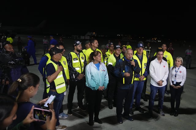 Venezuelan Interior Minister Diosdado Cabello, center, speaks to the press during the arrival of Venezuelan migrants deported from the United States at Simon Bolivar International Airport in Maiquetia, Venezuela, Monday, March 24, 2025. (AP Photo/Ariana Cubillos)