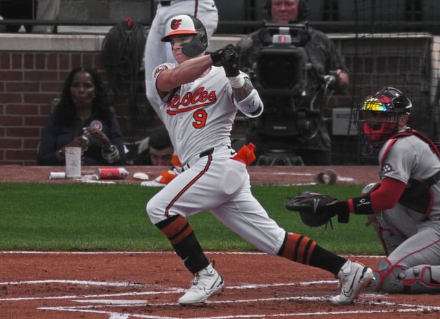 Orioles’ Tyler O’Neill singles to drive in Jordan Westburg against the Red Sox in the first inning of the 2025 season home opening day at Oriole Park at Camden Yards. (Kenneth K. Lam/Staff)