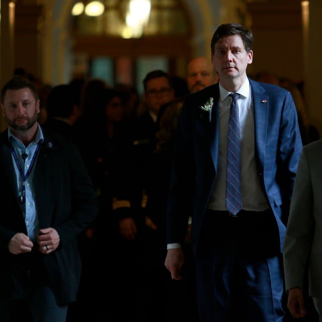 Premier David Eby walks back to his office following the throne speech at the legislature in Victoria, Tuesday, Feb. 18, 2025. THE CANADIAN PRESS/Chad Hipolito