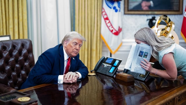 US President Donald Trump, left, and Karoline Leavitt, White House press secretary, speak during an executive order signing in the Oval Office of the White House in Washington, DC, US, on Monday, March 31, 2025.