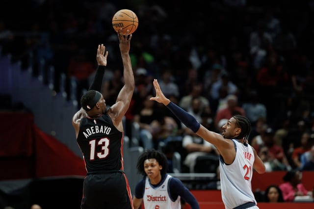 Miami Heat center Bam Adebayo (13) shoots over Washington Wizards forward Alex Sarr, right, during the first half of an NBA basketball game in Washington, Monday, March 31, 2025. (AP Photo/Terrance Williams)