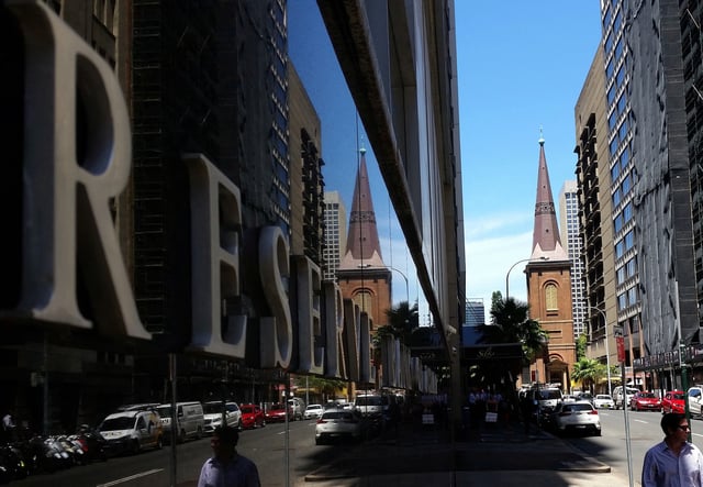 Pedestrians walk past the Reserve Bank of Australia building in central Sydney, Australia, February 10, 2017. REUTERS/Steven Saphore/File Photo