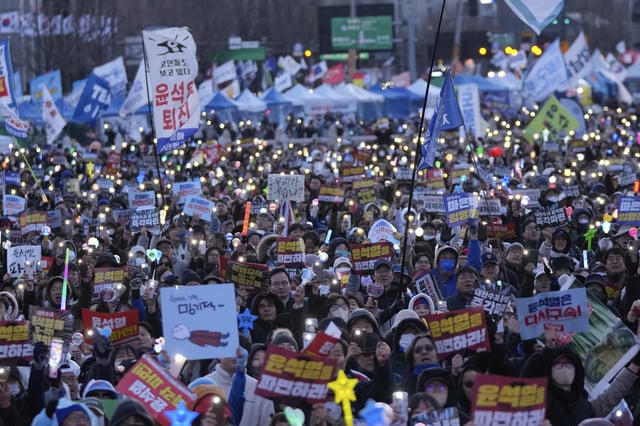 Protesters stage a rally calling for impeached South Korean President Yoon Suk Yeol to step down in Seoul, South Korea, Saturday, March 29, 2025. The banners read "Dismiss Yoon Suk Yeol." (AP Photo/Ahn Young-joon)