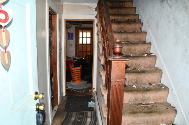 This picture shows trash and dirt in carpeted areas of the home where Kimberly Sullivan is accused of holding her stepson captive for 20 years.