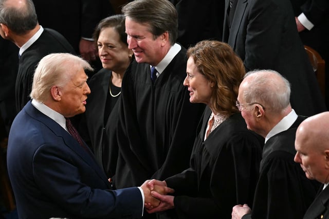 President Donald Trump shakes hands with US Supreme Court Associate Justice Amy Coney Barrett as Trump arrives to address to a joint session of Congress in the House Chamber of the US Capitol in Washington, DC, on March 4.