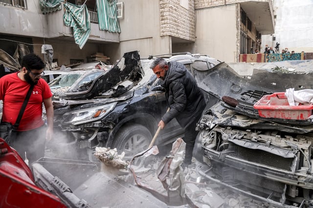 A man clears rubble from the site of an Israeli strike in Beirut, Lebanon on April 1, 2025. 