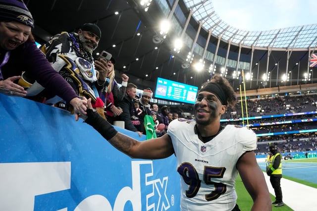 Baltimore Ravens linebacker Tavius Robinson (95) celebrates the team&#39;s 24-16 win against the Tennessee Titans with fans after an NFL football game Sunday, Oct. 15, 2023, at the Tottenham Hotspur stadium in London. (AP Photo/Kin Cheung)