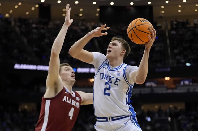 Duke forward Cooper Flagg (2) puts up a shot against Alabama guard Aden Holloway (2) during the first half of an Elite Eight round NCAA college basketball tournament game, Saturday, March 29, 2025, in Newark, N.J. 