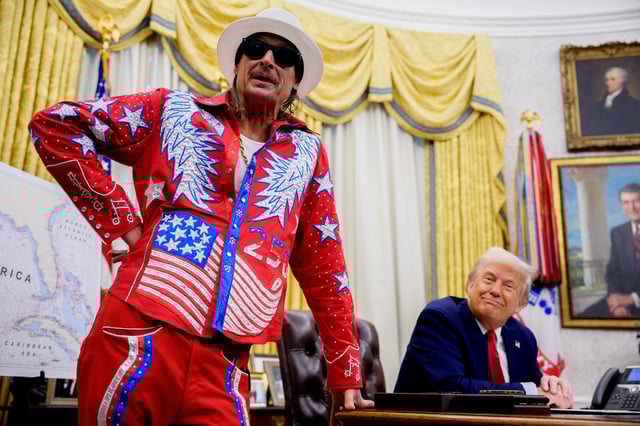 U.S. President Donald Trump listens as entertainer Kid Rock speaks during an executive order signing event in the Oval Office of the White House on March 31, 2025 in Washington, D.C. Trump has signed an executive order against ticket scalping and reforming the live entertainment ticket industry.