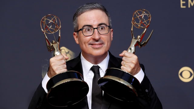 Comedian John Oliver poses with the awards for outstanding writing for a variety series and outstanding variety talk series, for &#34;Last Week Tonight With John Oliver&#34;, at the 73rd Primetime Emmy Awards in Los Angeles, U.S., September 19, 2021. REUTERS/Mario Anzuoni