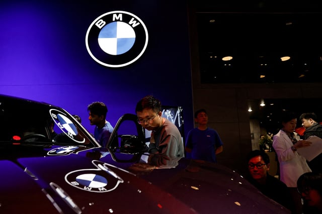 Visitors look at vehicle on display at the BMW booth, at the Beijing International Automotive Exhibition, or Auto China 2024, in Beijing, China, April 25, 2024. REUTERS/Tingshu Wang/File Photo
