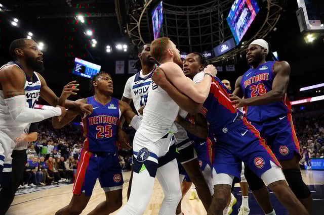 Ronald Holland II #00 of the Detroit Pistons and Donte DiVincenzo #0 of the Minnesota Timberwolves fight in the second quarter. Holland II and DiVincenzo were ejected from the game at Target Center on March 30, 2025 in Minneapolis, Minnesota.
