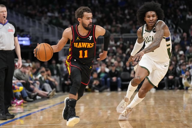 Mar 30, 2025; Milwaukee, Wisconsin, USA;  Atlanta Hawks guard Trae Young (11) drives for the basket in front of Milwaukee Bucks guard Kevin Porter Jr. (3) during the fourth quarter at Fiserv Forum. Mandatory Credit: Jeff Hanisch-Imagn Images/File Photo