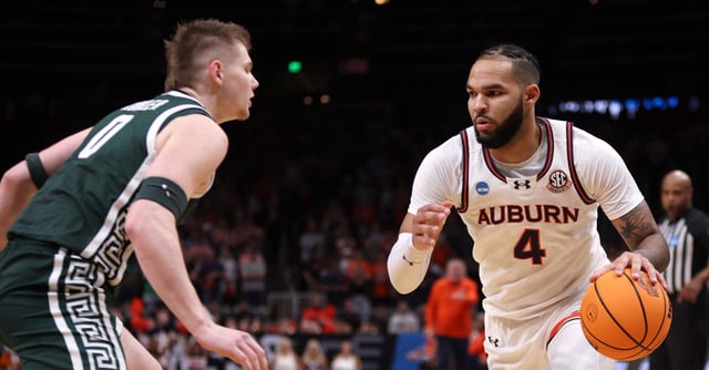 Mar 30, 2025; Atlanta, GA, USA; Auburn Tigers forward Johni Broome (4) dribbles against Michigan State Spartans forward Jaxon Kohler (0) during the first half in the South Regional final of the 2025 NCAA tournament at State Farm Arena. Mandatory Credit: Brett Davis-Imagn Images