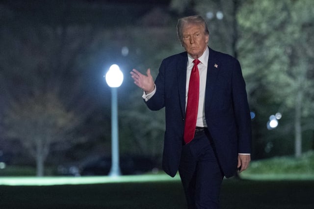President Donald Trump waves to the media as he walks on the South Lawn of the White House, in Washington, Sunday, March 30, 2025. (AP Photo/Jose Luis Magana)